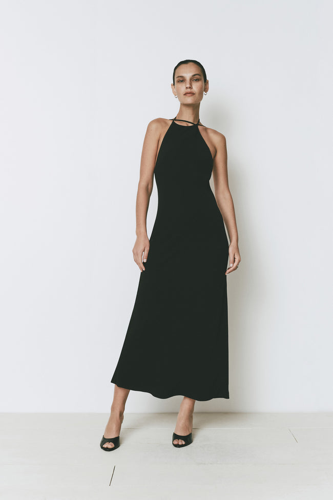 Ruesophie black sleeveless midi Opera Dress with elegant halter neck, worn by a model.