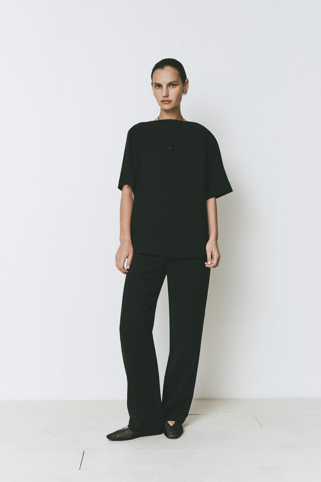 Black Dusk Boatneck Top with matching pants. Modern tailoring with high neckline and quarter sleeves. Rue Sophie.