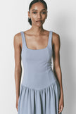 Light blue midi dress with square neckline and drop waist. Modern, minimalist design.