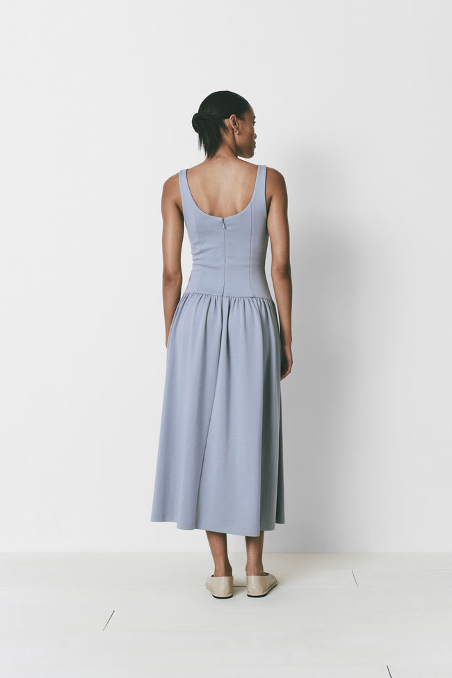 Light blue midi dress with drop waist, back zipper and smooth fabric