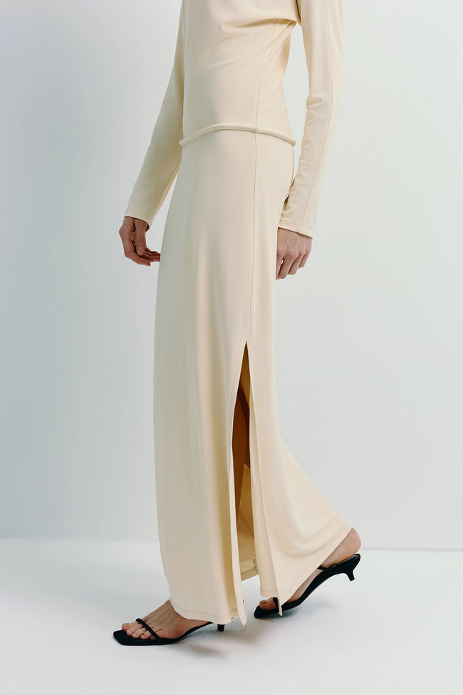 Agla Dolman Sleeve Dress in cream, midi length with side slit, featuring dolman sleeves and a relaxed fit.