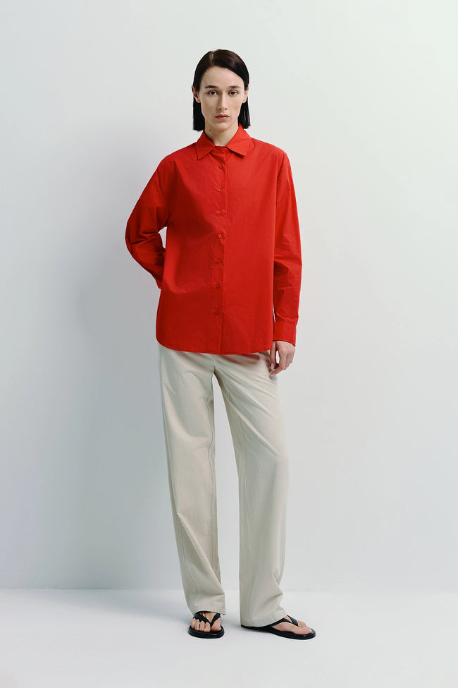 Woman in Red Shirt and Beige Metis Straight Leg Pants. Soft Cotton-Lyocell blend. Relaxed fit.