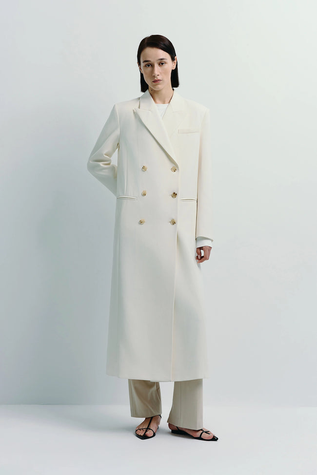 Remie Double Breast Coat in white. Classic double-breasted midi coat with gold buttons.