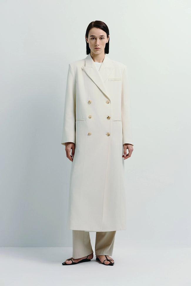 White Remie Double Breast Coat with gold buttons. Midi length, polyester-wool blend outerwear.