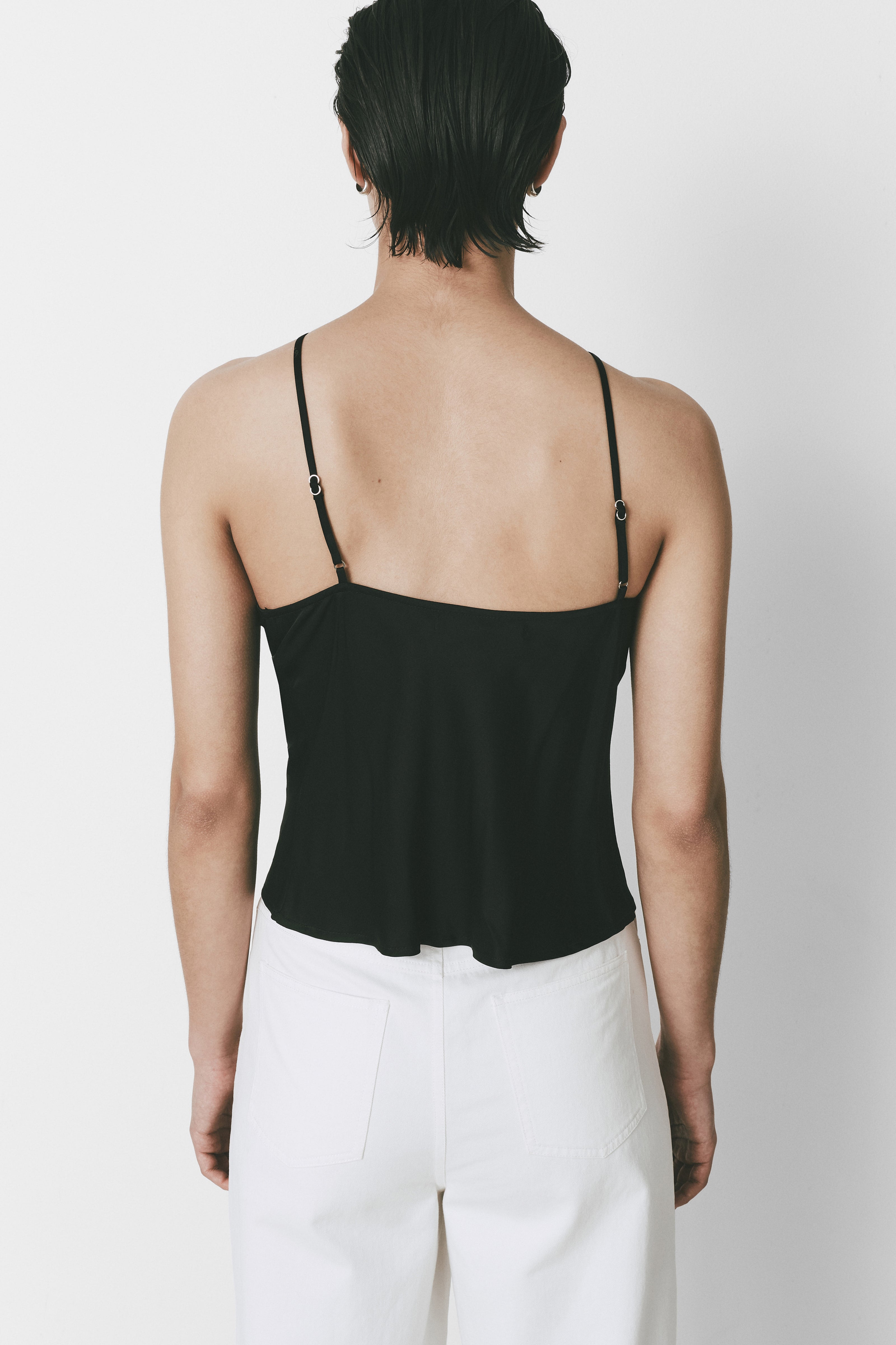 Yvoire Top in black with adjustable straps and satin-like texture