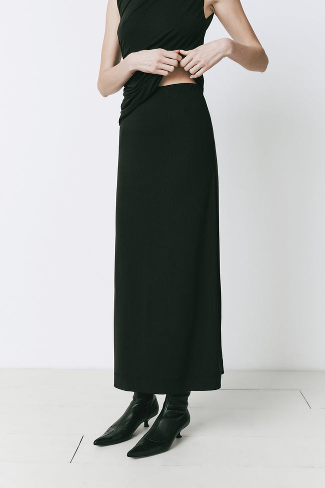 Alizé Modal Knit Skirt in black, midi length, styled with black top and boots, minimalist fashion