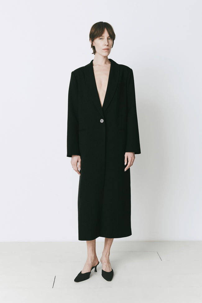 Augustin Deep Neck Coat in Black wool-poly blend, midi-length with a draped fit, from Rue Sophie.