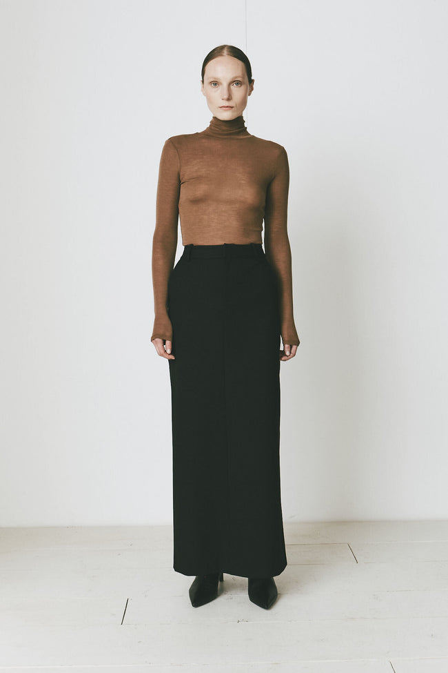 Tobacco wool turtleneck and black skirt from Rue Sophie, showcasing versatile, modern style