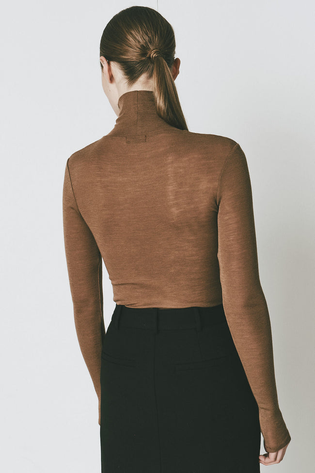 Rue Sophie Bellville Sheer Wool Top in tobacco color, showing the back of the model and sleek design.
