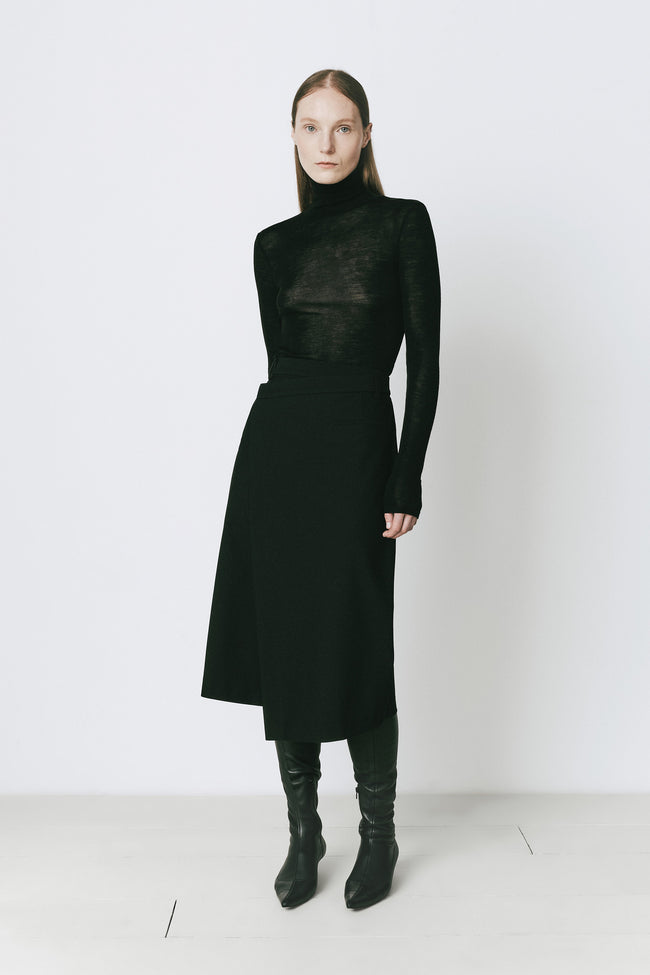 Black Belmont Wrap Skirt and top set with boots on a model against a white background