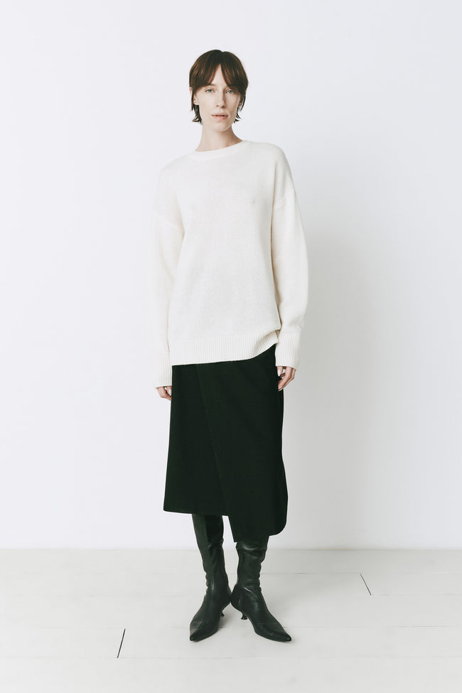 White Boulogne cashmere blend sweater with black skirt and boots