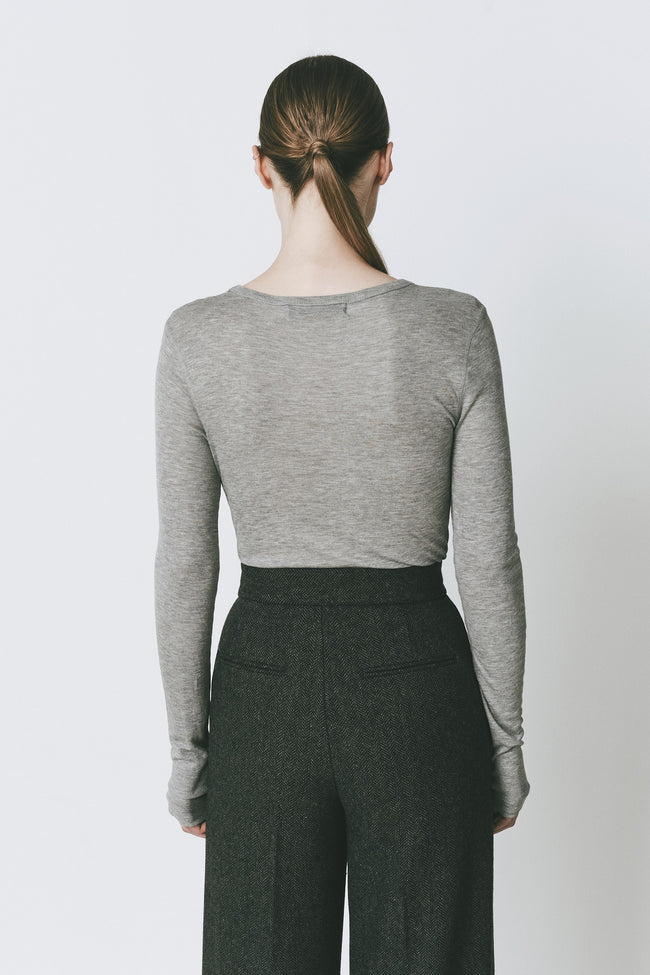 Grey long sleeve crewneck top with dark charcoal trousers. Slim fit, perfect for layering.
