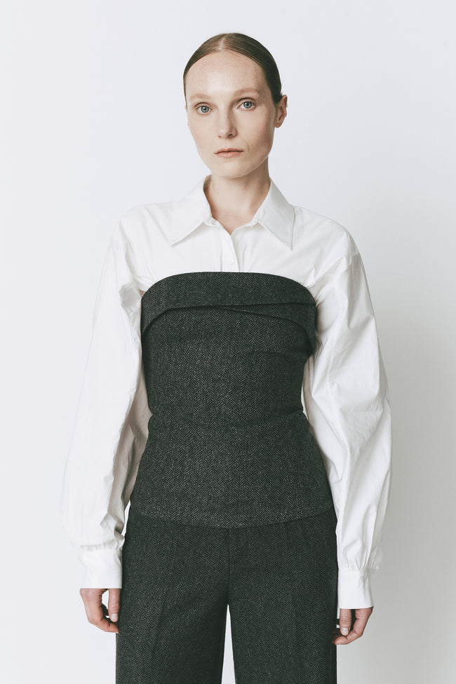 Concorde Bustier Top in Cinder herringbone wool blend, paired with white shirt, perfect for evening events.