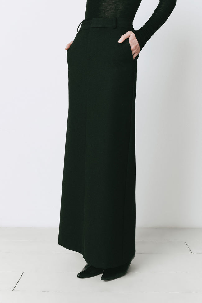 Black maxi skirt in polyester blend with flared hem; elegant, true-to-size fit.