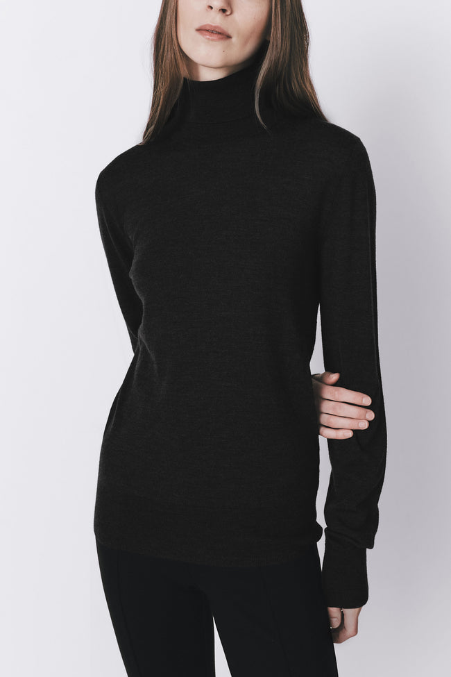 Black wool-silk blend turtleneck sweater from Rue Sophie, highlighting the tailored drape and luxury