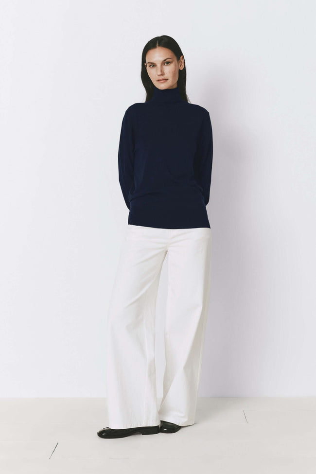 Navy wool and silk turtleneck sweater with white wide-leg pants. Sophisticated everyday style