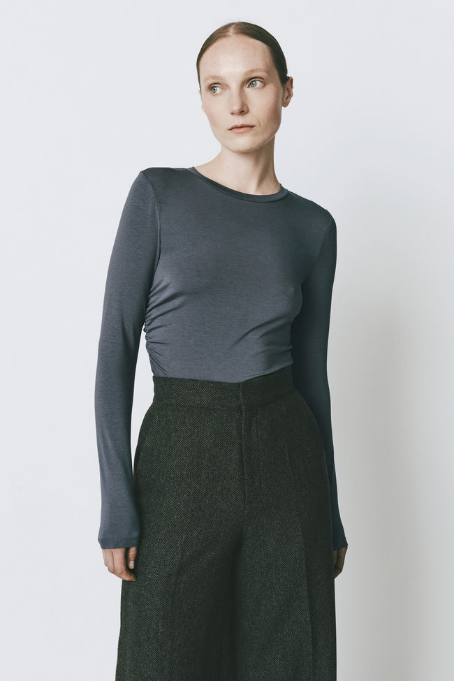 Du-Jour Ruched Top in Topaz Blue with Dark Green Herringbone Trousers, slim-fit elegant outfit.
