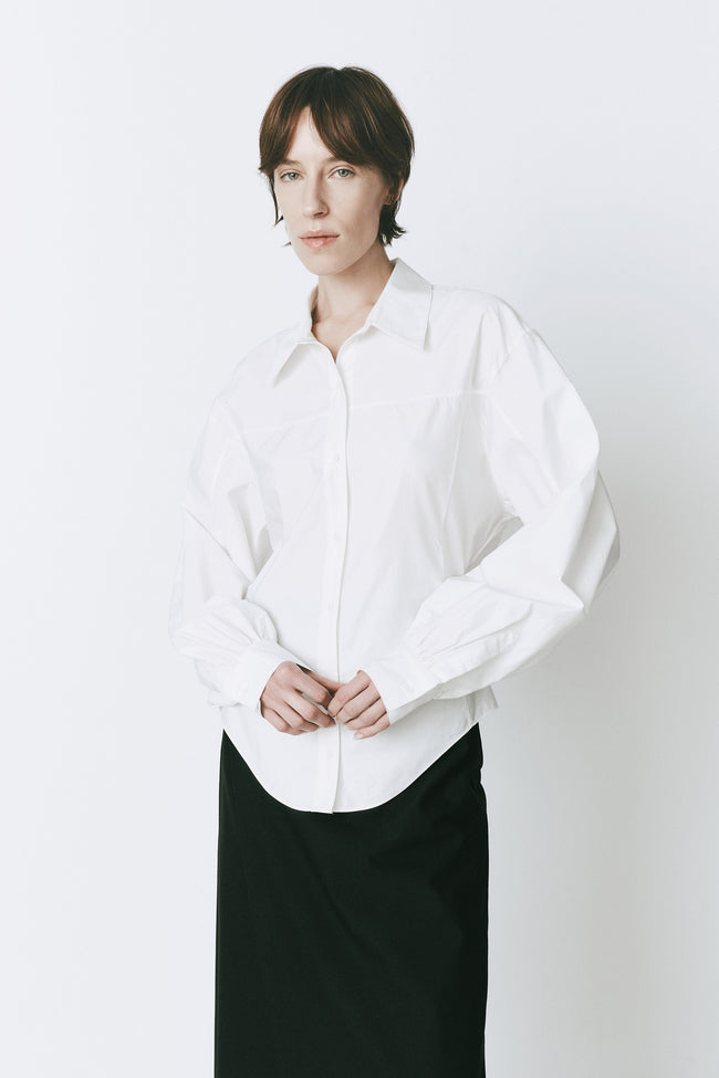 White cotton Fontaine Balloon Sleeve Shirt styled on a model, perfect for work or sophisticated outings.