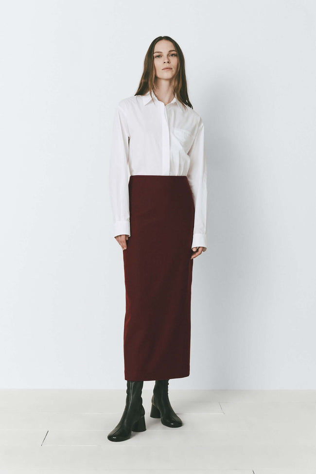 Bordeaux wool blend pencil skirt, white shirt, and black boots on a model