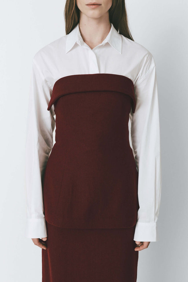Burgundy wool blend bandeau top with foldover detail, paired with white button-down shirt. Perfect for elevated style.