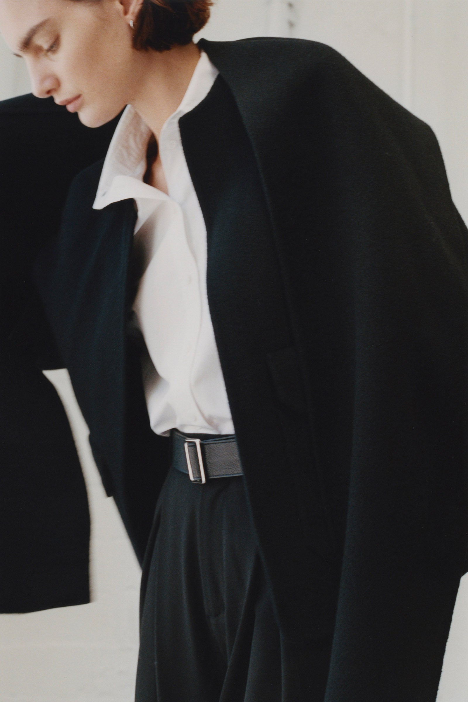 Rue Sophie Jardin Scarf Wool Jacket in black, woman wearing wool coat with belt and white shirt, minimalist look.