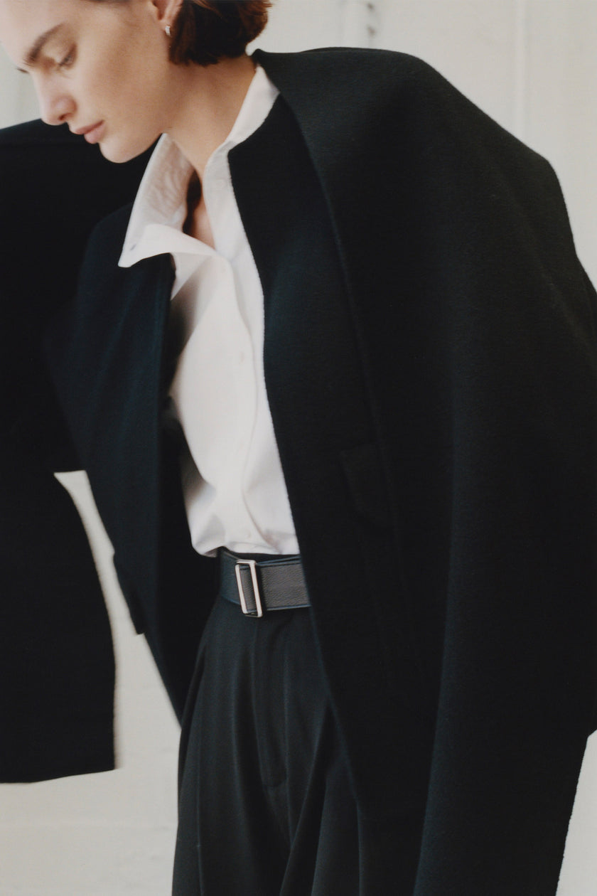 Rue Sophie Jardin Scarf Wool Jacket in black, woman wearing wool coat with belt and white shirt, minimalist look.