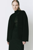 Woman in black Rue Sophie Jardin Wool & Cashmere Jacket, minimalist modern fashion, detachable scarf detail, loose fit