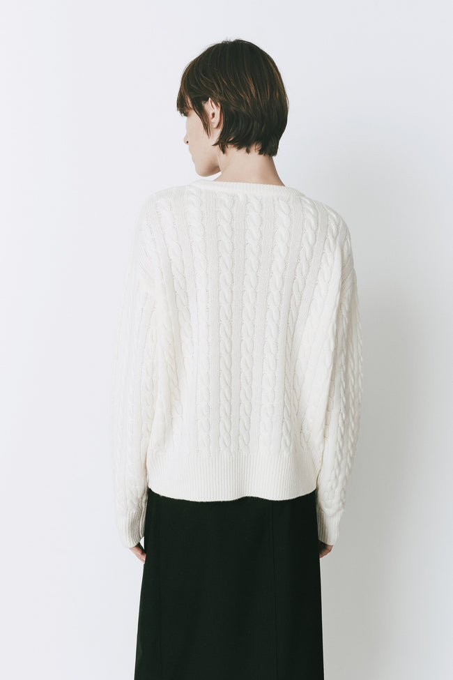 Ivory wool-cashmere cable knit sweater on a woman, perfect for layering.