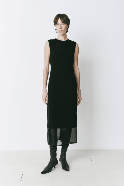 Black Marceau Organza Hem Midi Dress, sleeveless with organza hem, paired with leather boots
