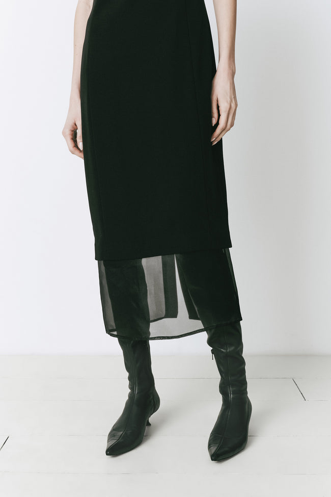 Black Marceau Organza Hem Midi Dress with black boots, ideal for evening and casual wear.
