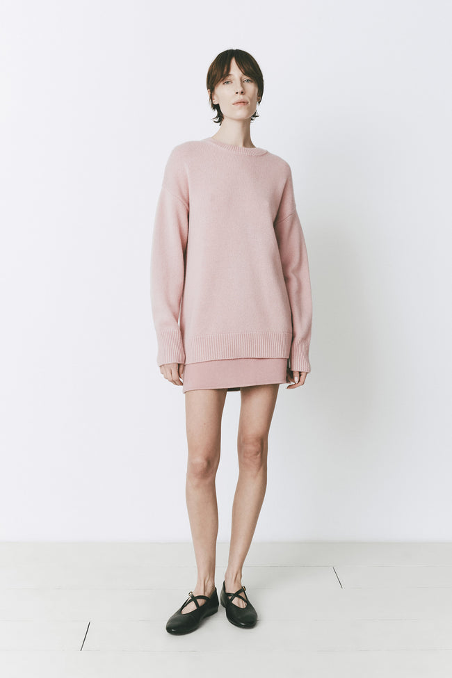 Mirabeau Mini Skirt in rose paired with sweater. Sleek fit, wool blend, perfect for layering.