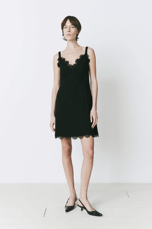 Black Rêve Lace Trimmed Mini Dress with lace trim, woman in heels
