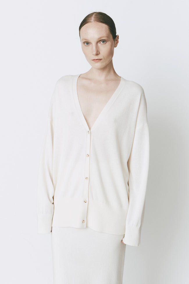 Versailles Button Front Cardigan in Glacier wool-cashmere, featuring a woman wearing the loose fit cardigan.