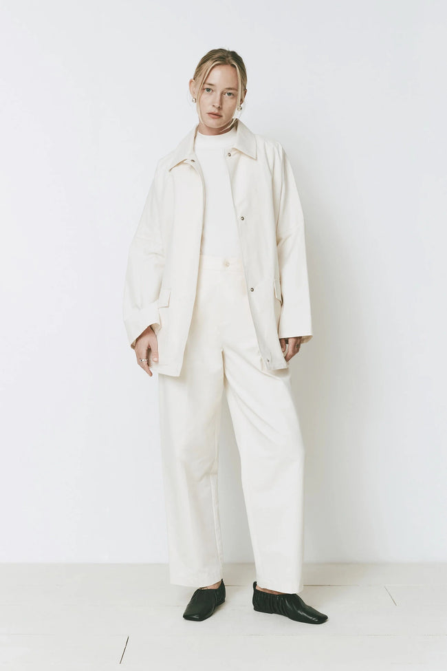Woman wearing the Parc Pant in cream color, featuring a tailored jacket and wide-leg trousers.
