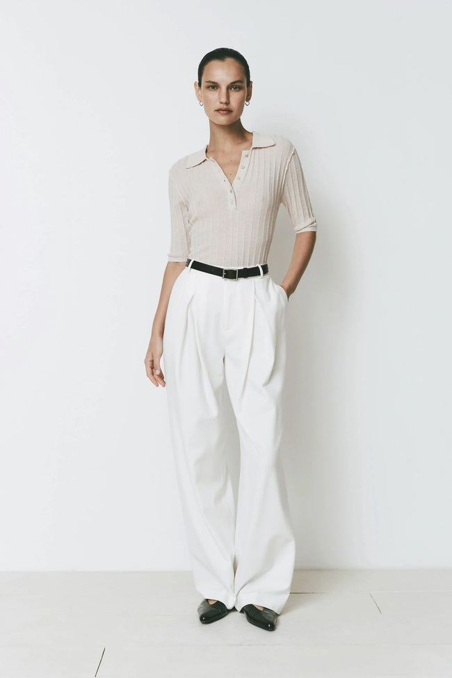 Woman in beige shirt and white Drapé Pants with front pleated detail