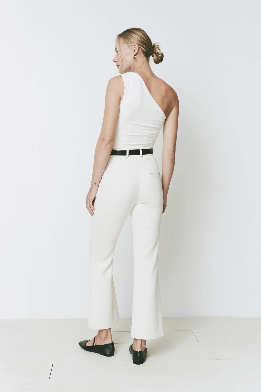 Cream Ruesophie Gesture Flare Pants on a woman, showing tailored back fit, clean lines, and subtle kick hem.