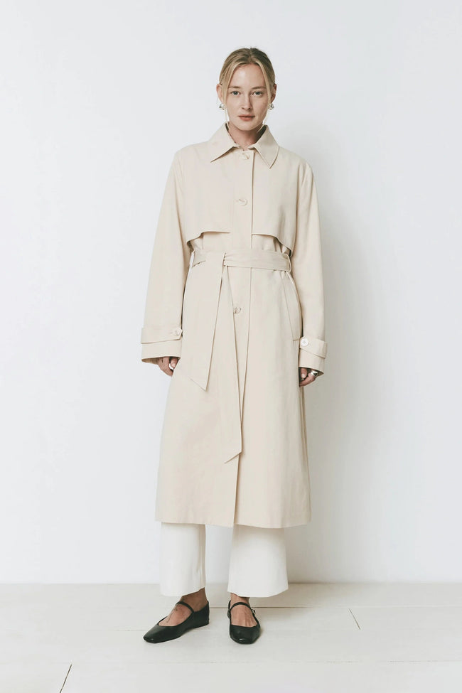 Cassis Trench Coat, classic trench coat with adjustable belt and wide collar, beige color.