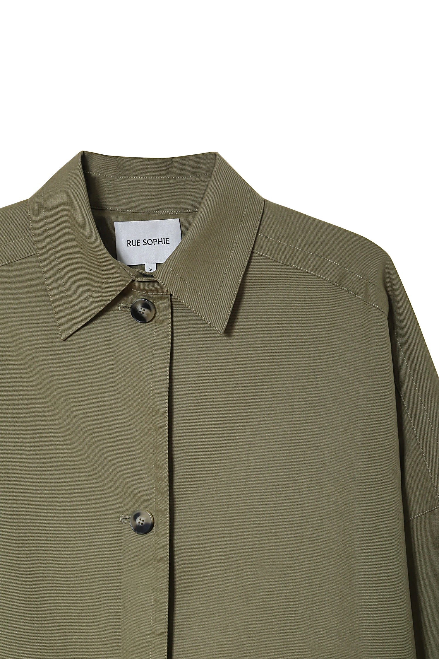 Provenance Oversized Jacket in Mosswood by RUE SOPHIE. Detail of collar and button closure.