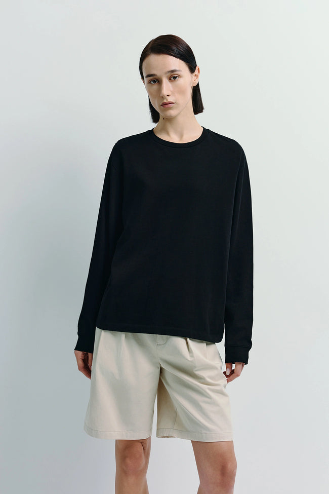 Anza Long Sleeve Top in black cotton blend, crewneck shirt, styled with shorts