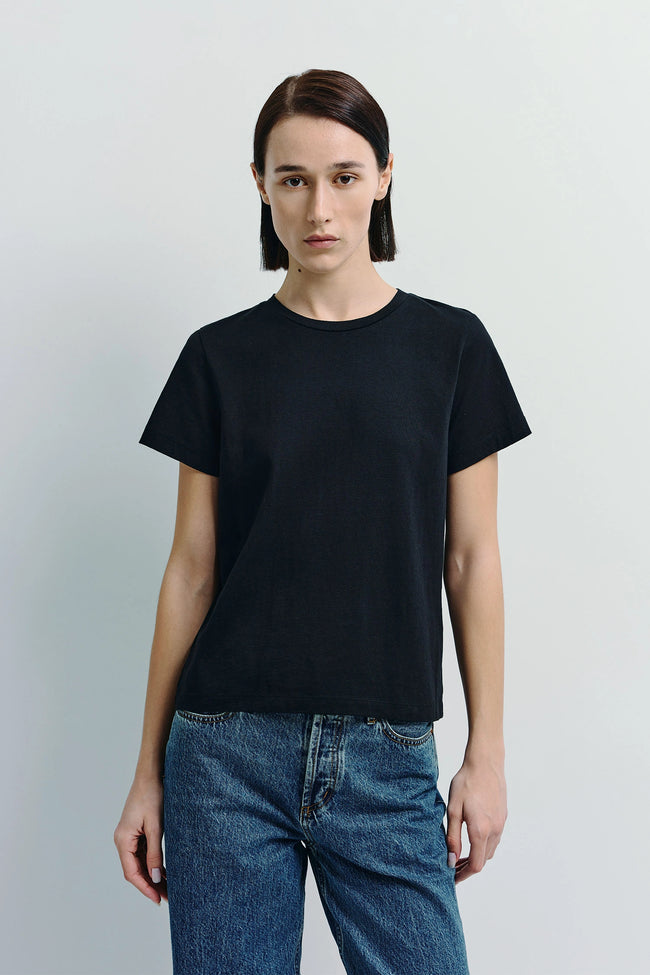 Black Fay Crew Neck Tee made of sustainable cotton, paired with blue jeans, for a minimalist style.