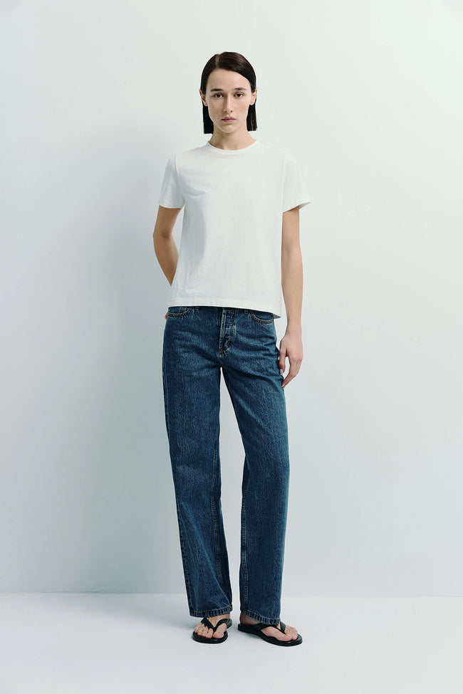 Woman wearing a white Fay Crew Neck Tee paired with denim jeans, crafted from sustainable cotton