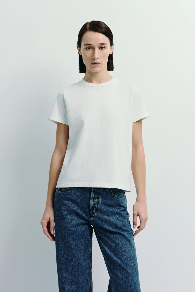 Woman wearing Fay Crew Neck Tee, made of sustainable cotton, paired with denim jeans