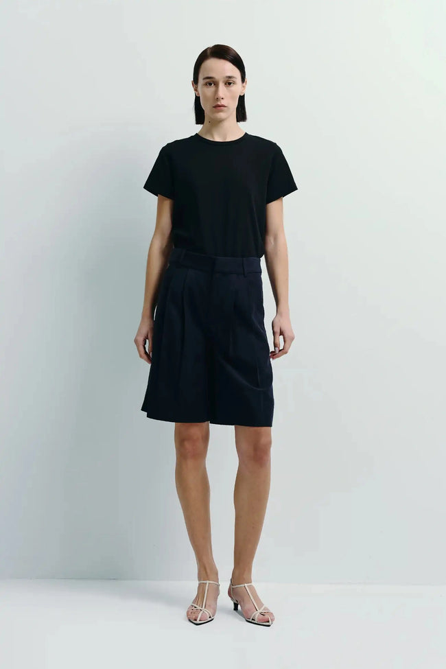 Navy lyocell and linen École Bermuda shorts with black tee, perfect for refined, warm-weather wear