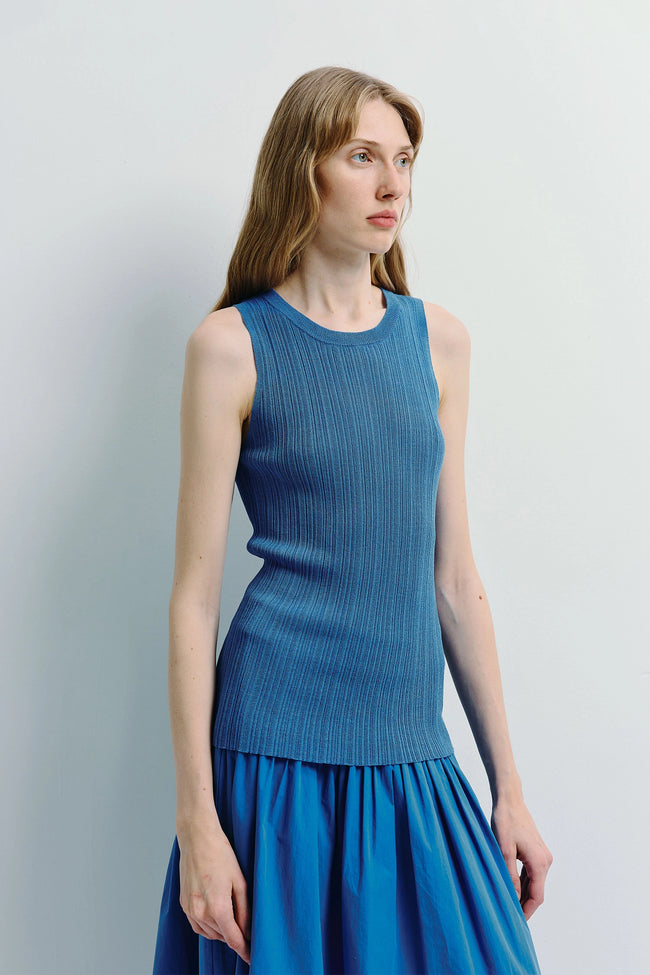 Monique Ribbed Knit Top in blue. A woman wearing a blue sleeveless top and skirt made of ribbed knit fabric.