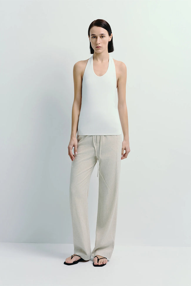 Chaleur Halter Top - Minimalist white halter top and beige linen pants, soft and breathable fabric.
