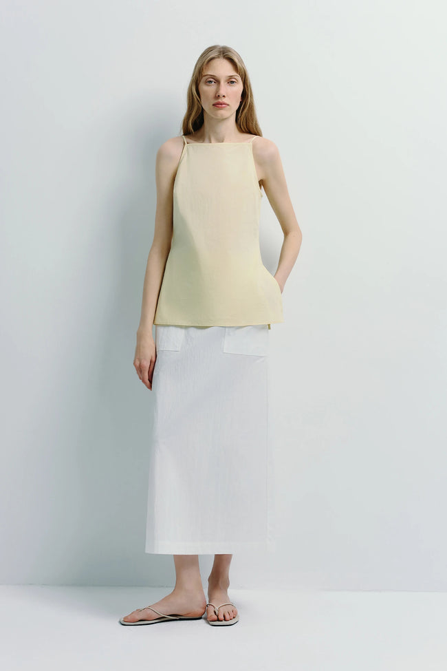 Vélo Square Neck Cami Top in pale yellow, with a white skirt and sandals, minimalist cotton design