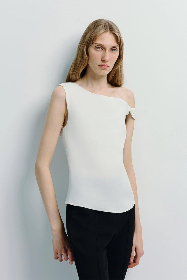 Off-shoulder white top and black pants on a model - elegant and modern Ruesophie style