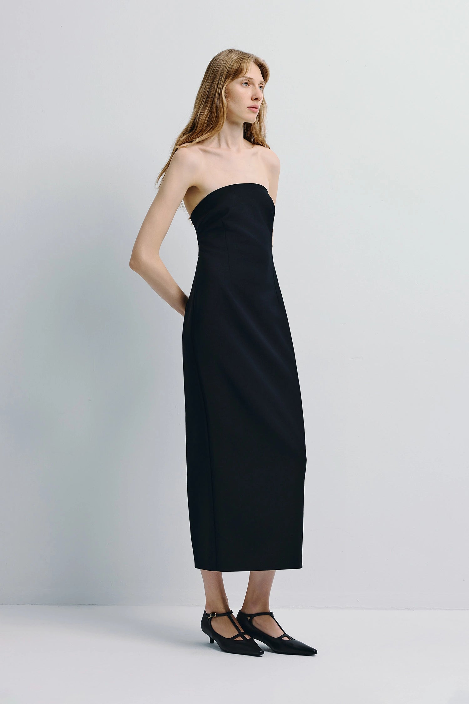 Black Webster Tube Dress. Strapless wool blend midi dress with tailored fit and sculpted silhouette.