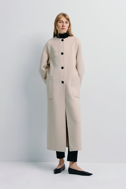 Iana Collarless Coat in beige. Wool-alpaca-silk blend coat with pockets for women. Elegant and minimalist outerwear.