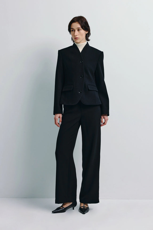 Camberly Collarless Blazer in black, wool-cashmere-silk blend, modern tailoring. Black trousers.